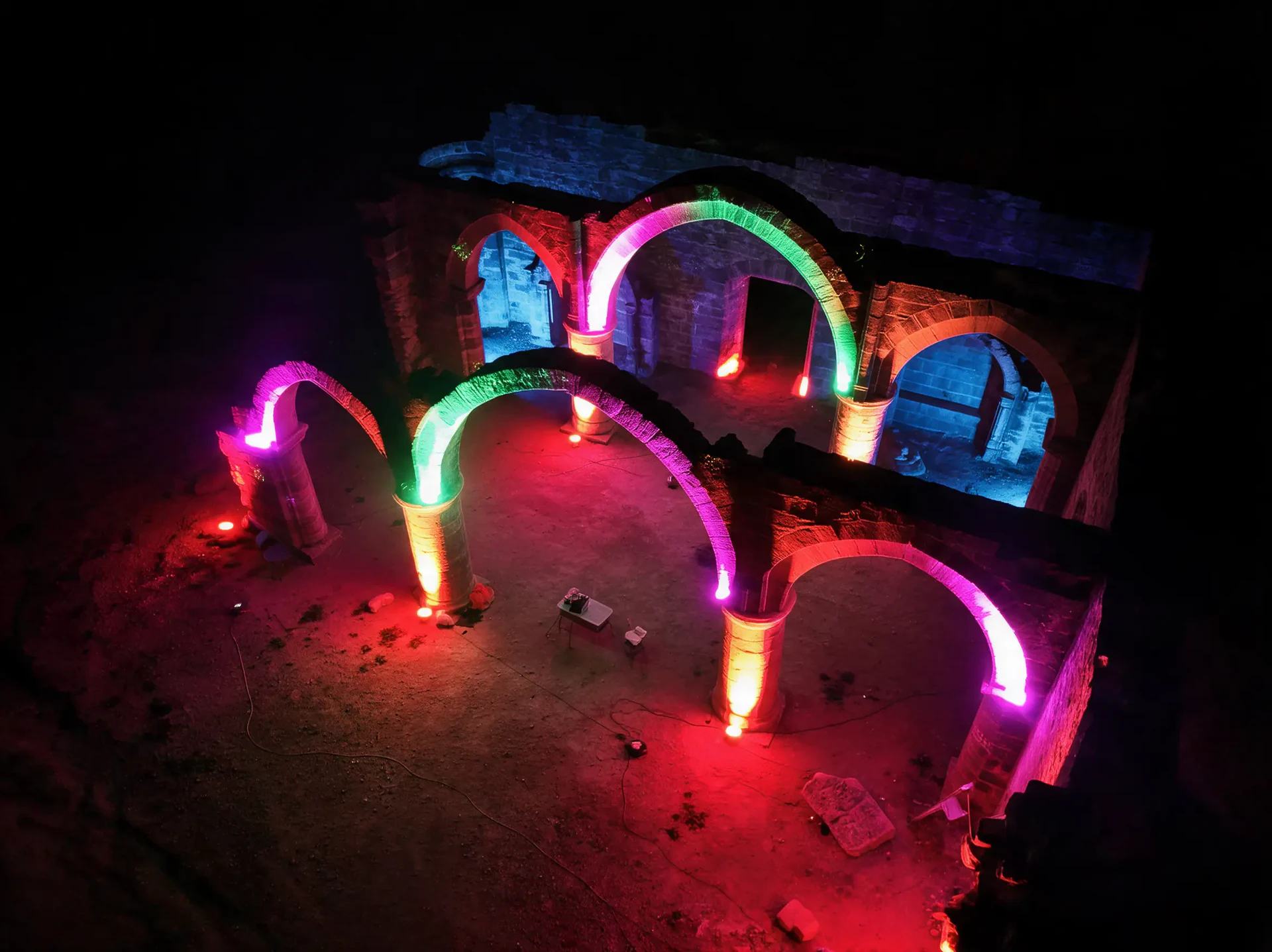Curved sculptural arches illuminated in red, green, cyan and violet
